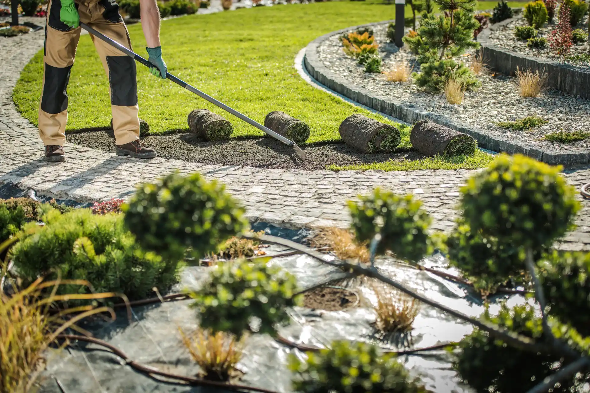 Custom stone masonry walkway and garden bed in a professionally designed landscape